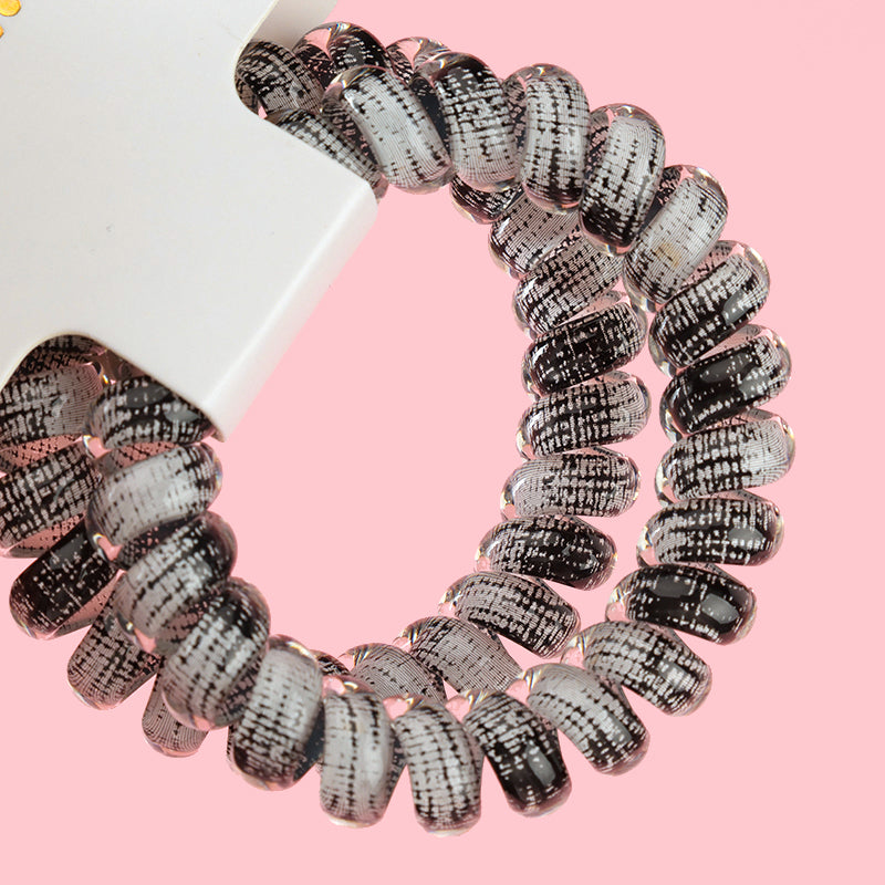 M42 two gray-series telephone cord hair ties in a box