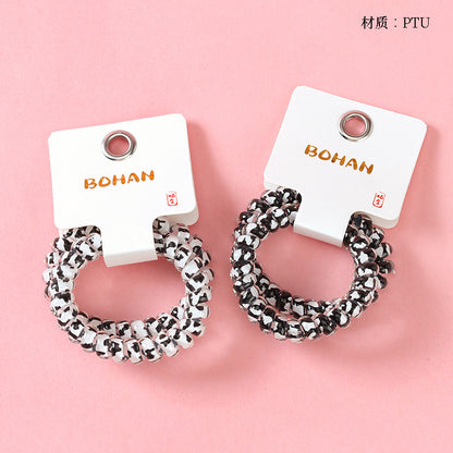 M42 two milk-pattern polka dot telephone cord hair ties in a box