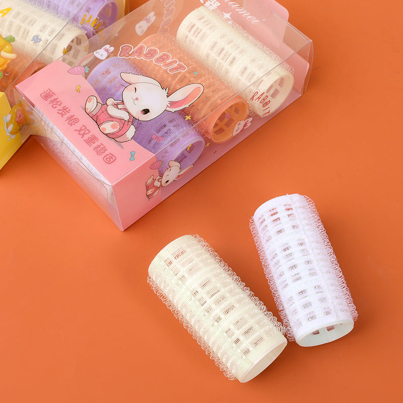 086 box containing four sticky hair curlers M.50