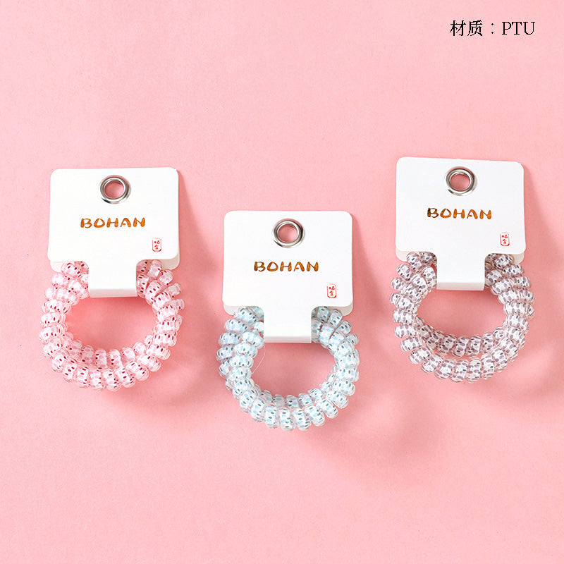 M42 two raindrop-printed telephone cord hair ties in a box