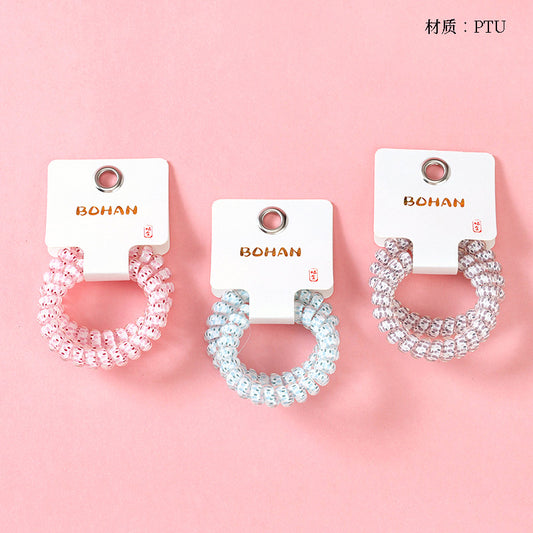 M42 two raindrop-printed telephone cord hair ties in a box