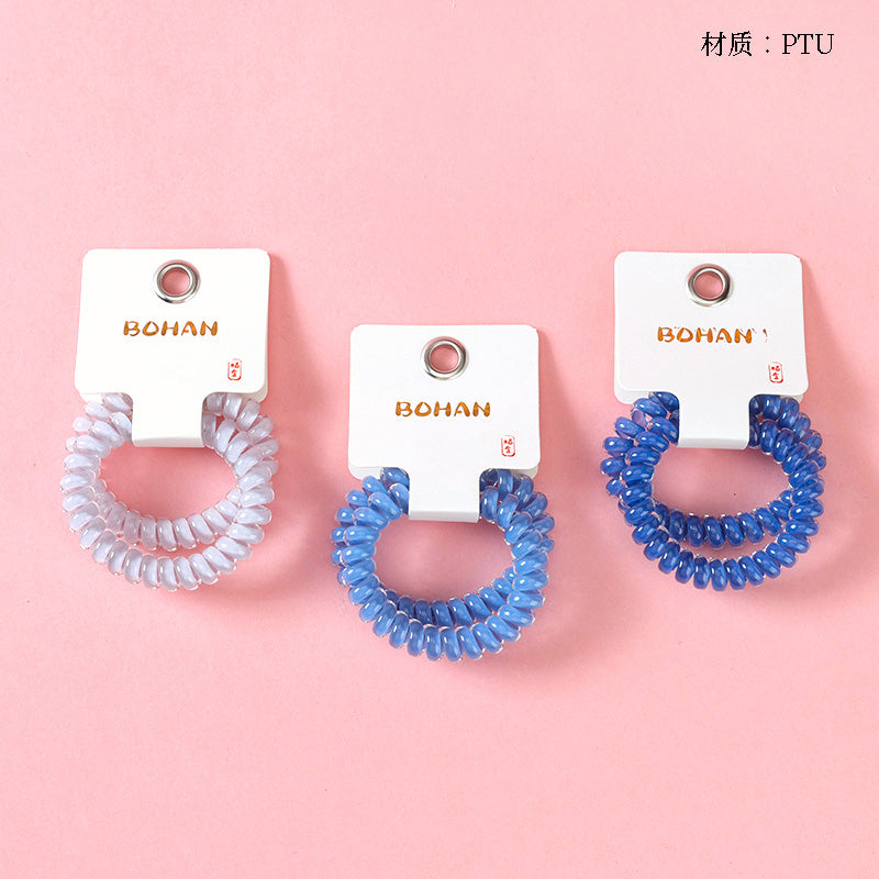 M42 two milk-blue series telephone cord hair ties in a box