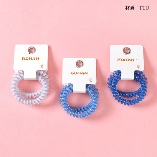 M42 two milk-blue series telephone cord hair ties in a box