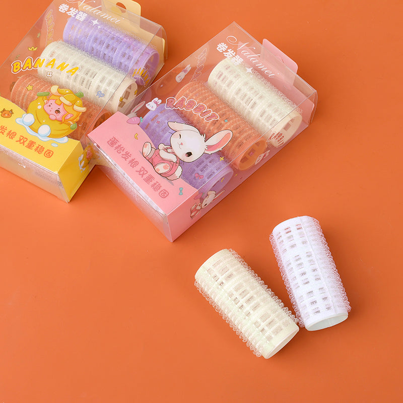 086 box containing four sticky hair curlers M.50