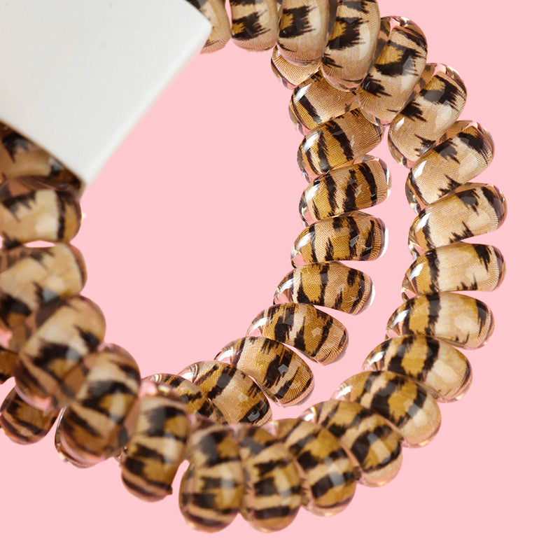M42 two leopard-print telephone cord hair ties in a box