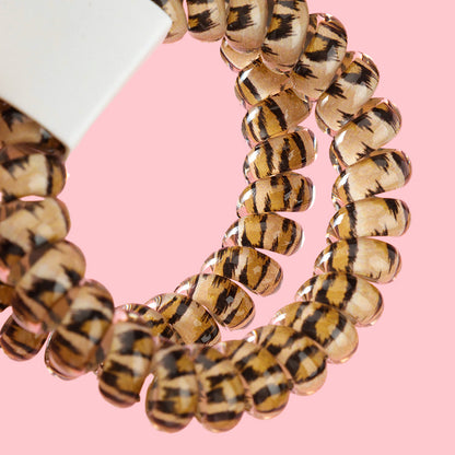 M42 two leopard-print telephone cord hair ties in a box