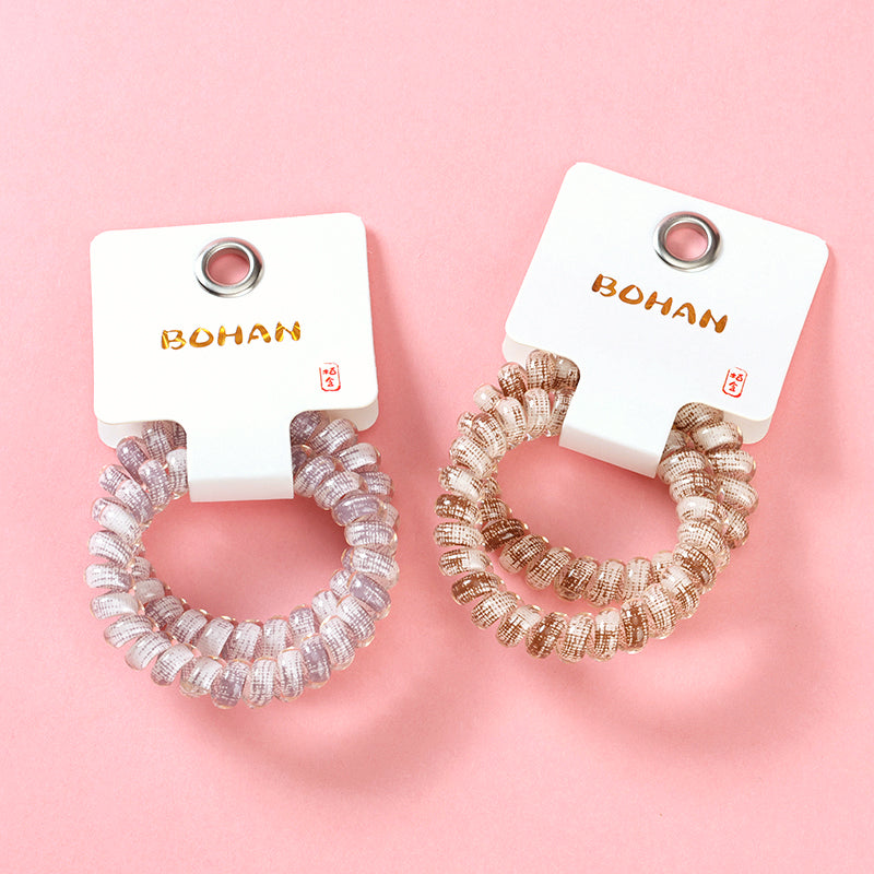 M42 two plaid-printed telephone cord hair ties in a box