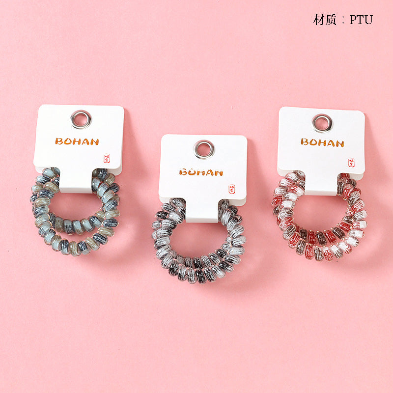 M42 two gray-series telephone cord hair ties in a box