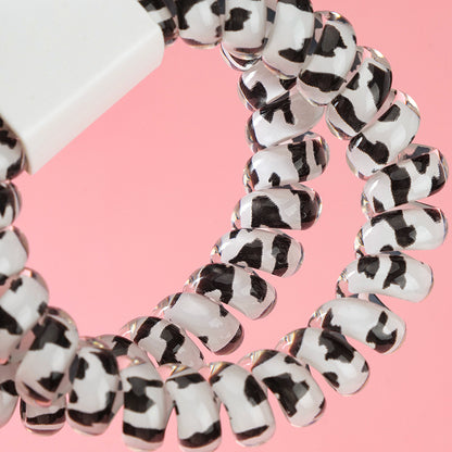 M42 two milk-pattern polka dot telephone cord hair ties in a box